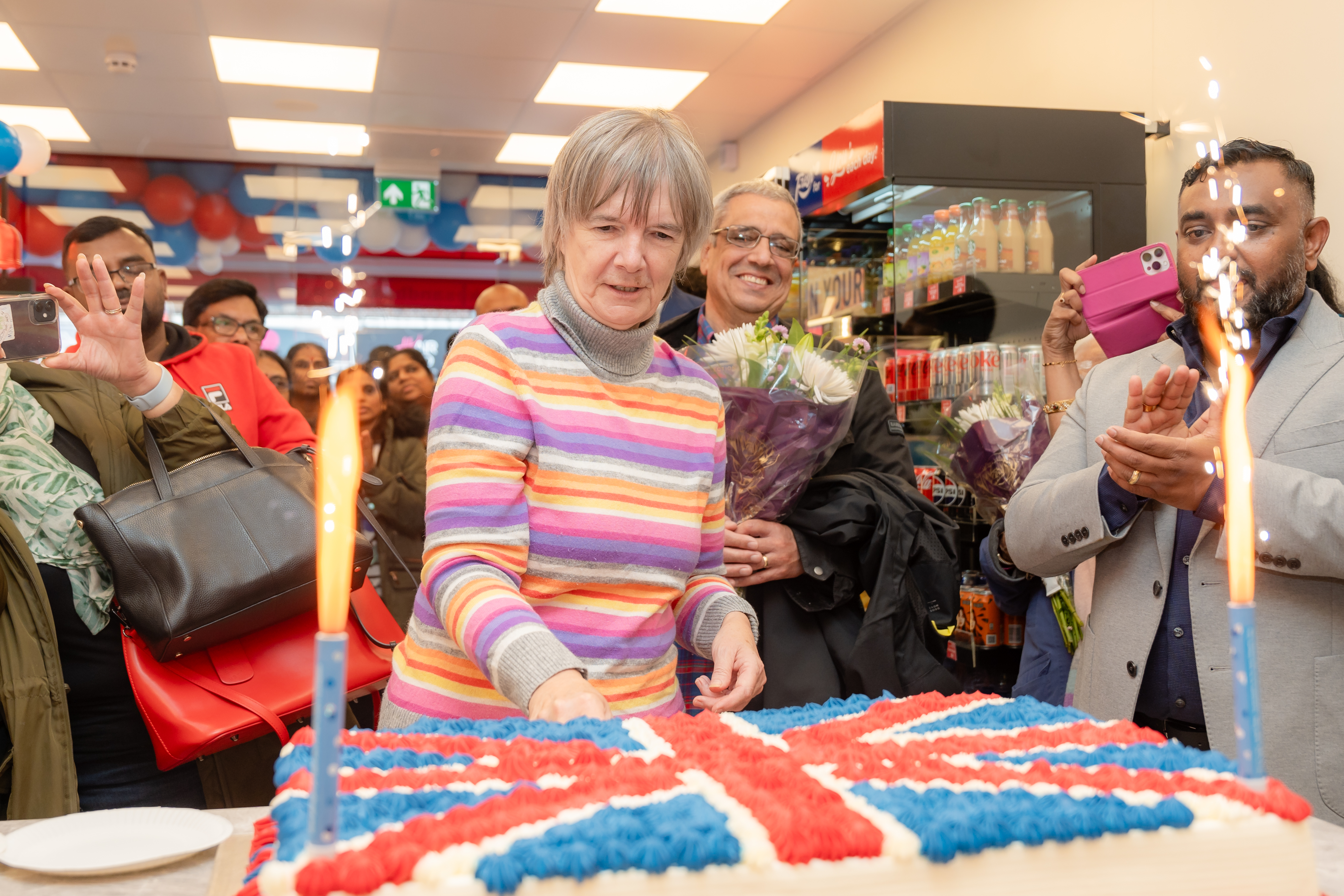 Three celebration cakes on stands.