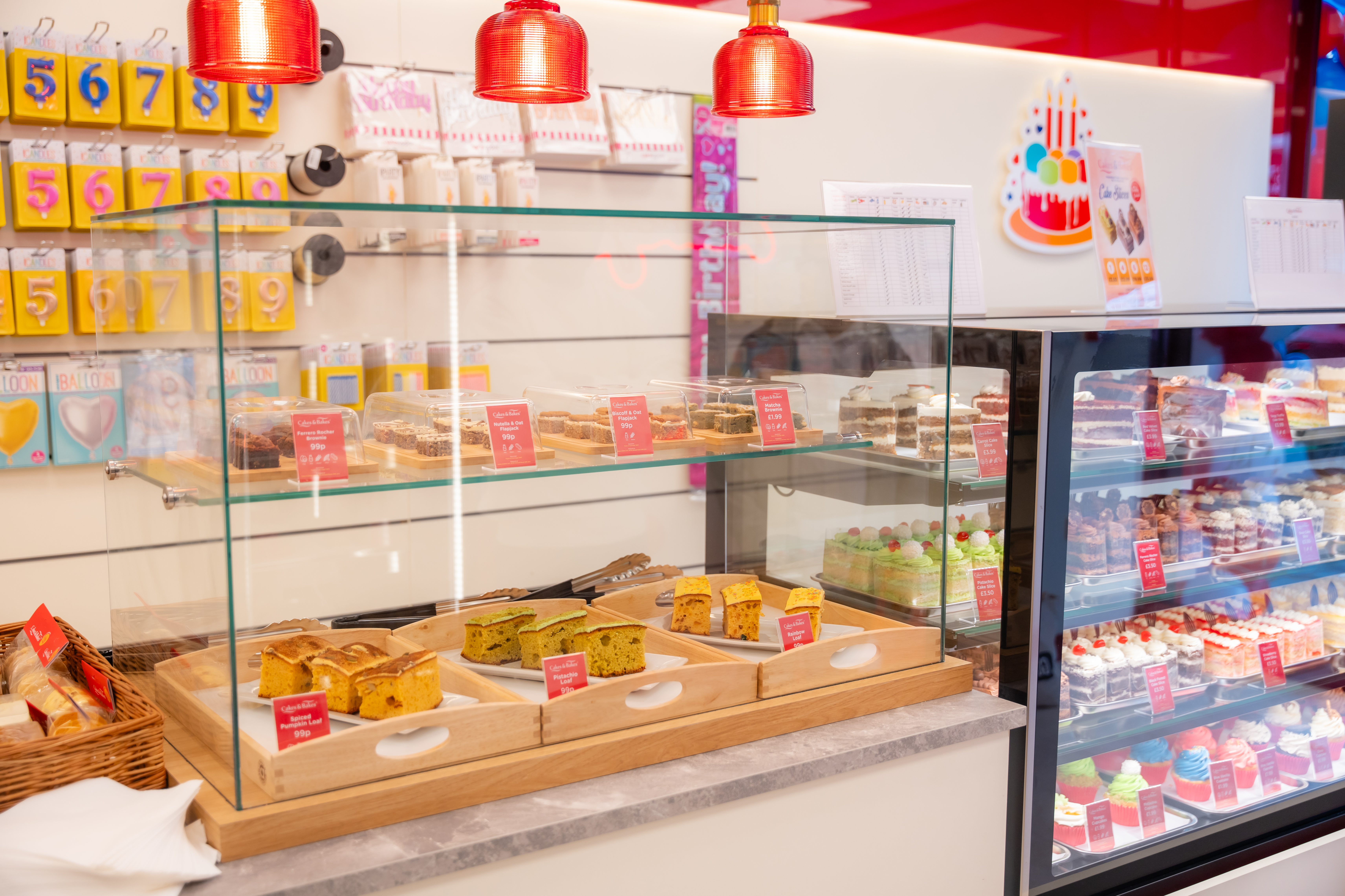 Three celebration cakes on stands.